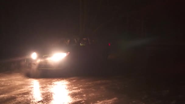 Night shot of a car on a surface of frozen lake trys to drift lighted only — Stock Video