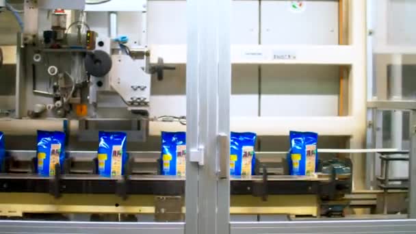 Traslado de paquetes de pasta en una línea transportadora con cierre automático. — Vídeo de stock