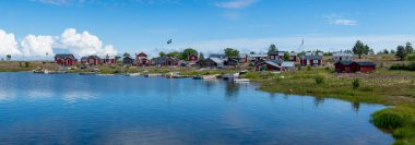 Traditional Fishing Village and Boat houses by the lake on Stor-Rabben Island, Near Pitea in the Archipelago of Gulf of Bothnia in Northern Sweden. clipart