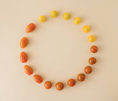 Juicy tomatoes of different species and shapes, arranged in a cyrcle with copy space. fresh vegetables. healthy cooking. healthy life.Healthy food. Healty cusine. Minimal flat lay.