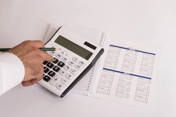 Calculator and calendar on white — Stock Photo, Image