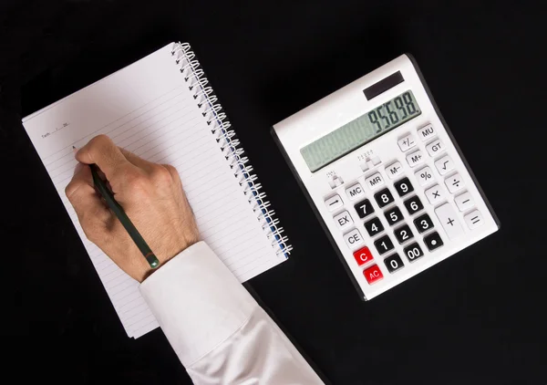 Calculator and taking note — Stock Photo, Image