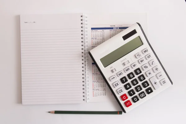 Isolated calculator on calendar and empty page — Stock Photo, Image