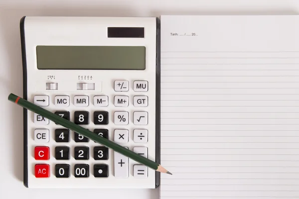 Calculator and empty page — Stock Photo, Image