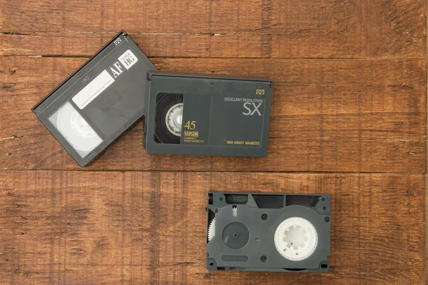 Video tapes and wood background — Stock Photo, Image