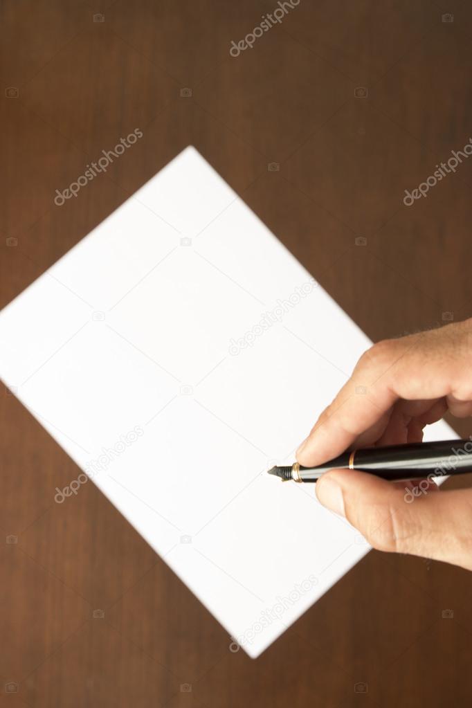 hand and pen writing letter