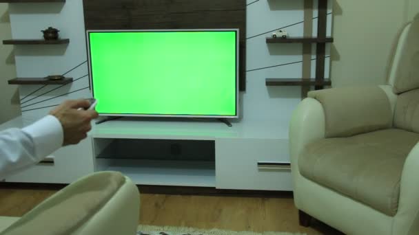 Control remoto de televisión y pantalla verde — Vídeos de Stock