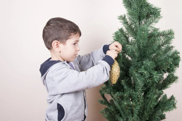 boy hanging decor christmas tree