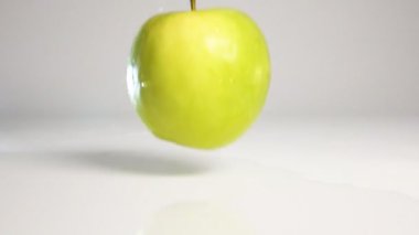 Green apple Fall on white surface