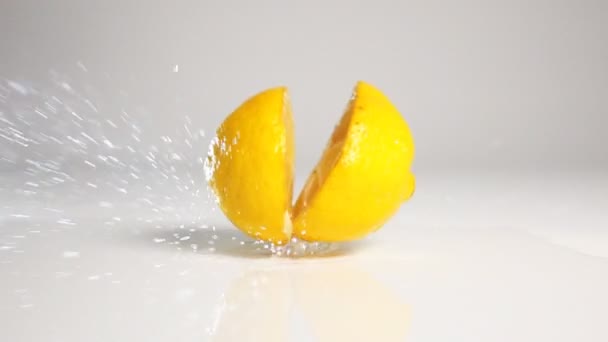 Two Lemon halfs dropping down — Stock Video