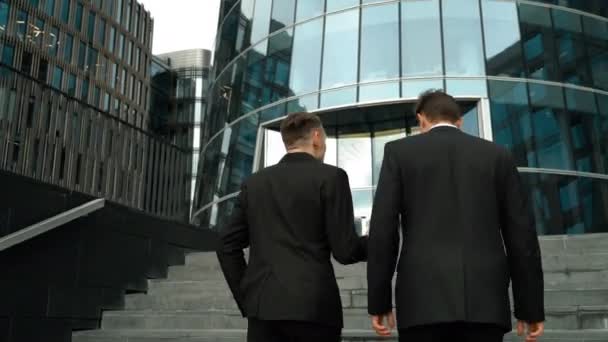 Two businessmen climb the stairs — Stock Video