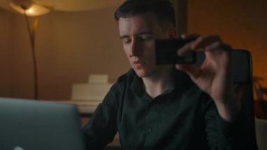 Genç yakışıklı adam, kredi kartı ve dizüstü bilgisayarla online alışveriş yapıyor.