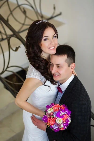 Just married do embrace on the stairs — Stock Photo, Image