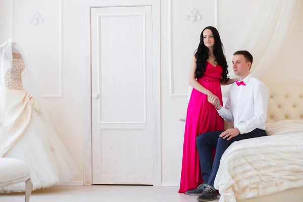 The girl in a pink dress and guy in the butterfly room for honey Stock Picture