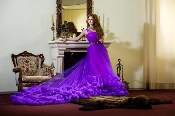 Woman in a luxury, long purple dress Royalty Free Stock Photos