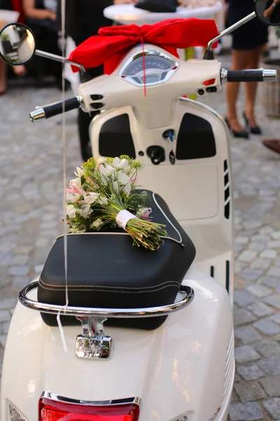 Vintage Vespa scooter with bouquet — Stock Photo, Image