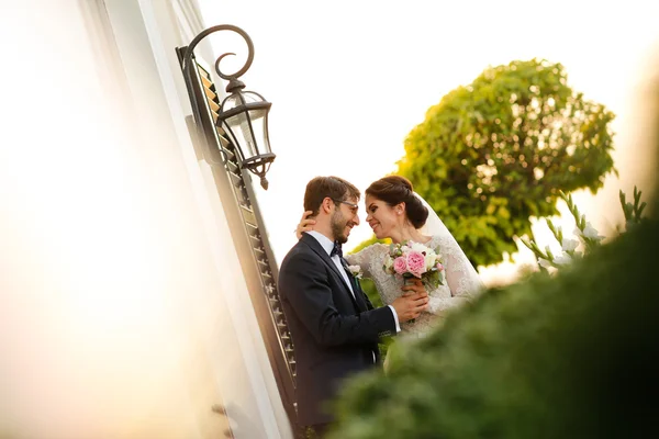 Radostné nevěsta a ženich s kyticí všeobjímající venku — Stock fotografie