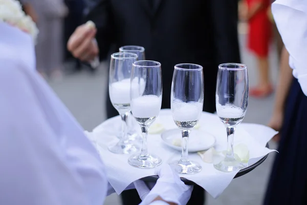 Waiter serving champagne on a tray — Stock Photo, Image