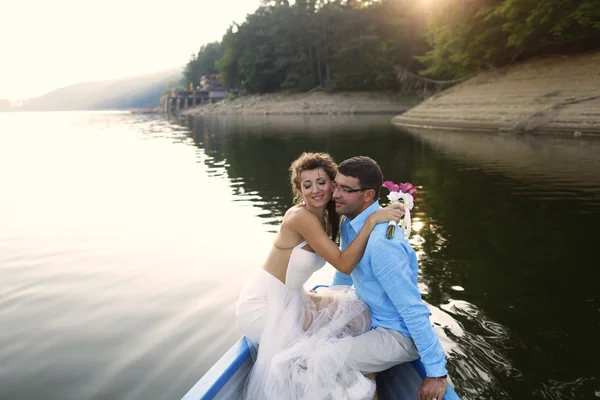 Belo casal nupcial abraçando no barco — Fotografia de Stock