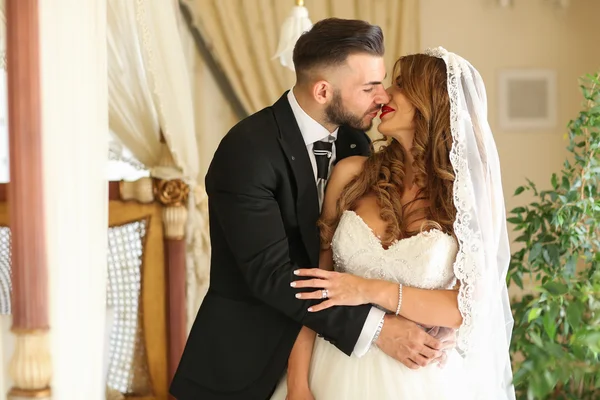 Lovely bride and groom, holding each other outside — Stock Photo, Image