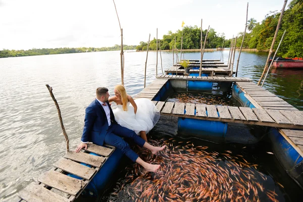 Noivo e noiva sentados no convés — Fotografia de Stock