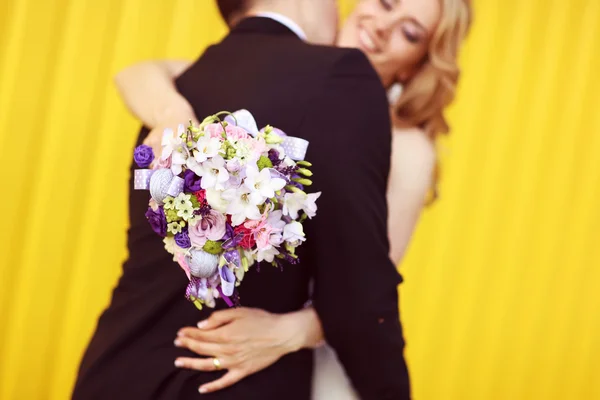 Bride and groom on a yellow background — Stock Photo, Image