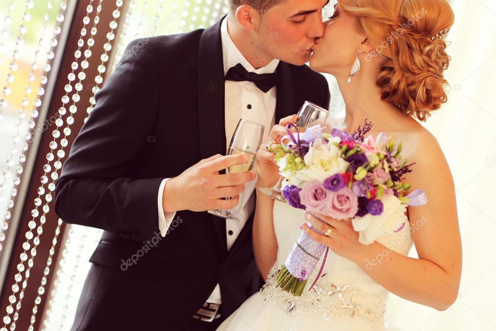 Bride and groom holding glasses of champagne