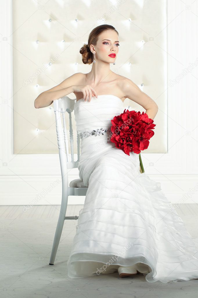 Gorgeous bride in a white room, posing