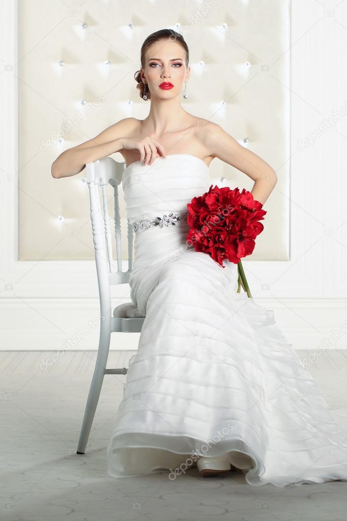 Gorgeous bride in a white room, posing