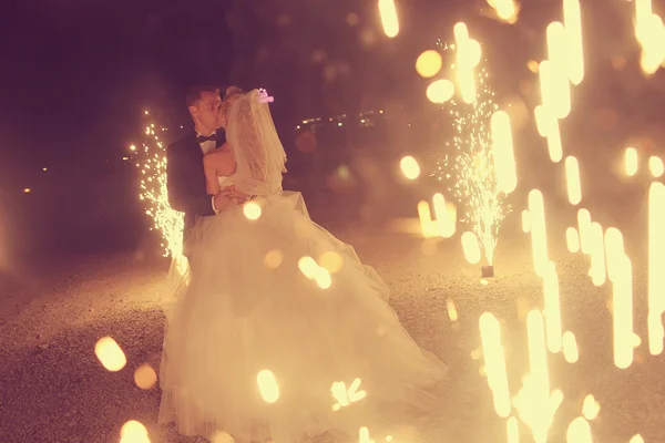 Bridal couple dancing sorrounded by fireworks — Stock Photo, Image