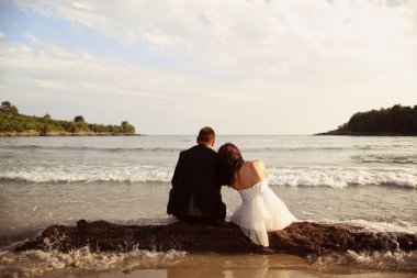 Gelin ve damat sahilde oturmuş