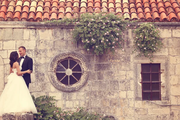 Sposa e sposo posa vicino alla vecchia casa — Foto Stock