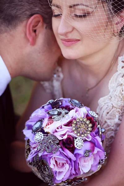 Groom kissing his bride on the shoulder — Stock Photo, Image