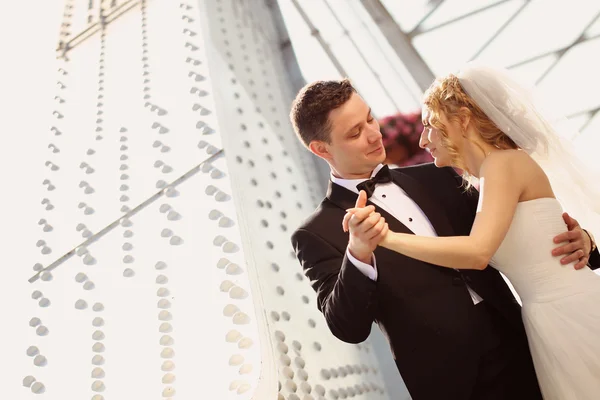 Glückliche Braut und Bräutigam auf Brücke — Stockfoto