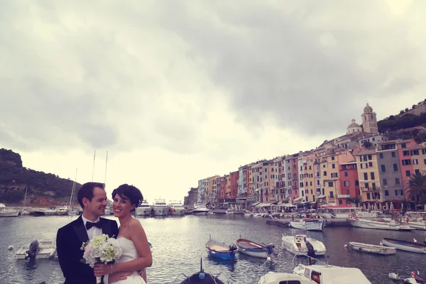 Noiva e noivo na ponte com barcos no fundo — Fotografia de Stock