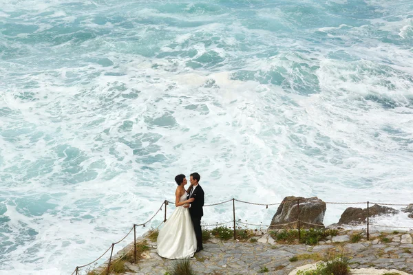 Happy bridal couple near seaside — Stock Photo, Image