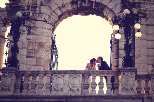 Bride and groom on a balcony — Stock Photo, Image