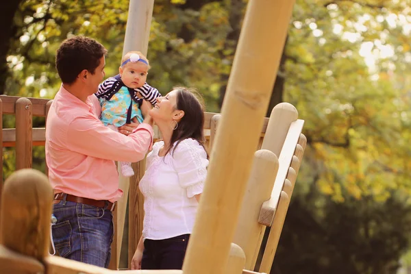 Pais afetuosos com sua menina no parque — Fotografia de Stock