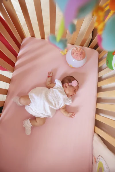 Beautiul meisje van de baby in haar bed — Stockfoto