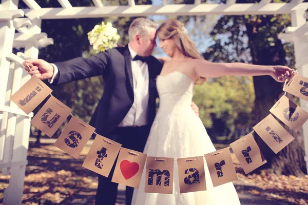 Couple holding Just Married signs — Stock Photo, Image