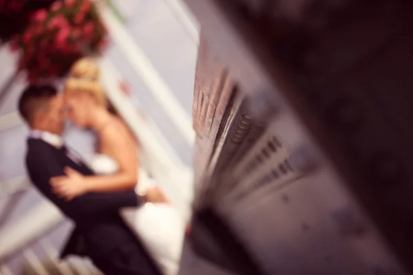 Bride and groom on a metallic bridge — Stock Photo, Image