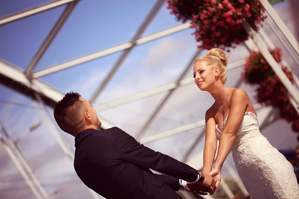 Bride and groom on a metallic bridge — Stock Photo, Image