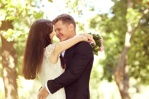 Beautiful couple embracing in park — Stock Photo, Image