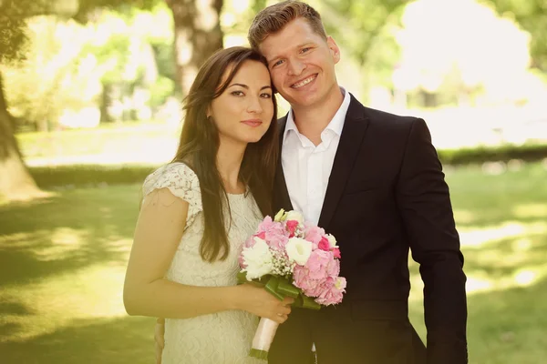 Beautiful couple embracing in park — Stock Photo, Image