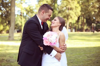 Gelin ve damat parkta kucaklayan