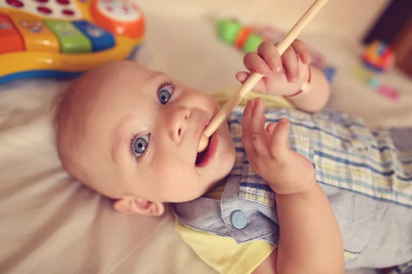 Small kid playing with drum stick — Stock Photo, Image