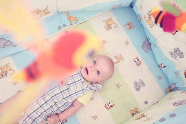 Playful kid in his bed — Stock Photo, Image