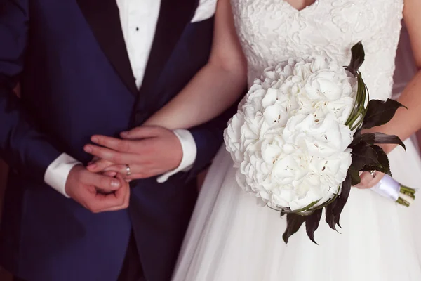 Detail of a bride and groom holding hands — Stock Photo, Image