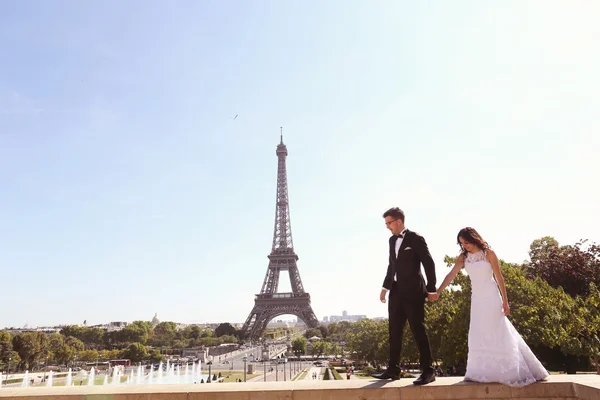 Mariée et marié marchant près de la fontaine à Paris — Photo