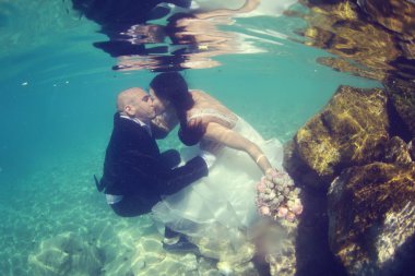 Gelin ve damat su altında öpüşme